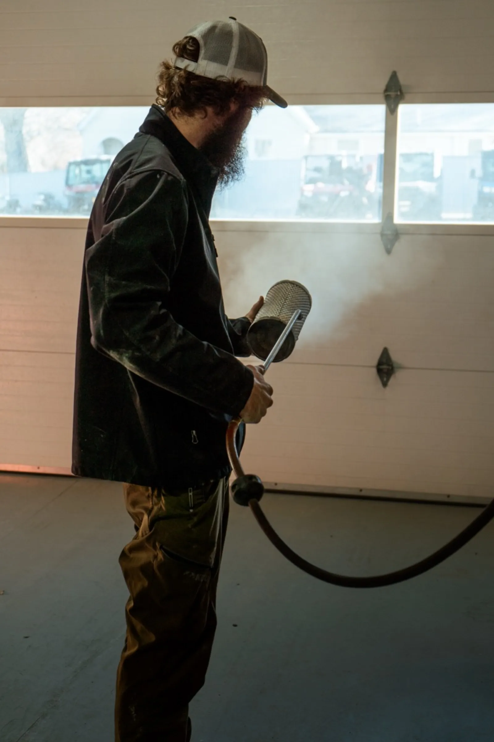 D&P Performance technician cleaning air filter with compressed air during powersports service
