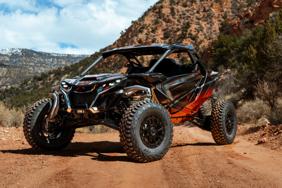 Can-Am Maverick R on a red dirt trail in Southern Utah mountains showing the kind of machine buyers invest in
