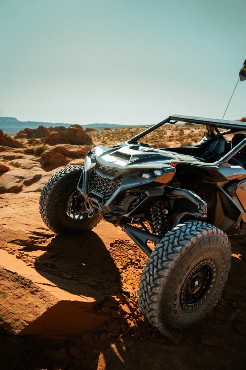 Can-Am Maverick X3 positioned on red rock terrain in Southern Utah with desert vista behind