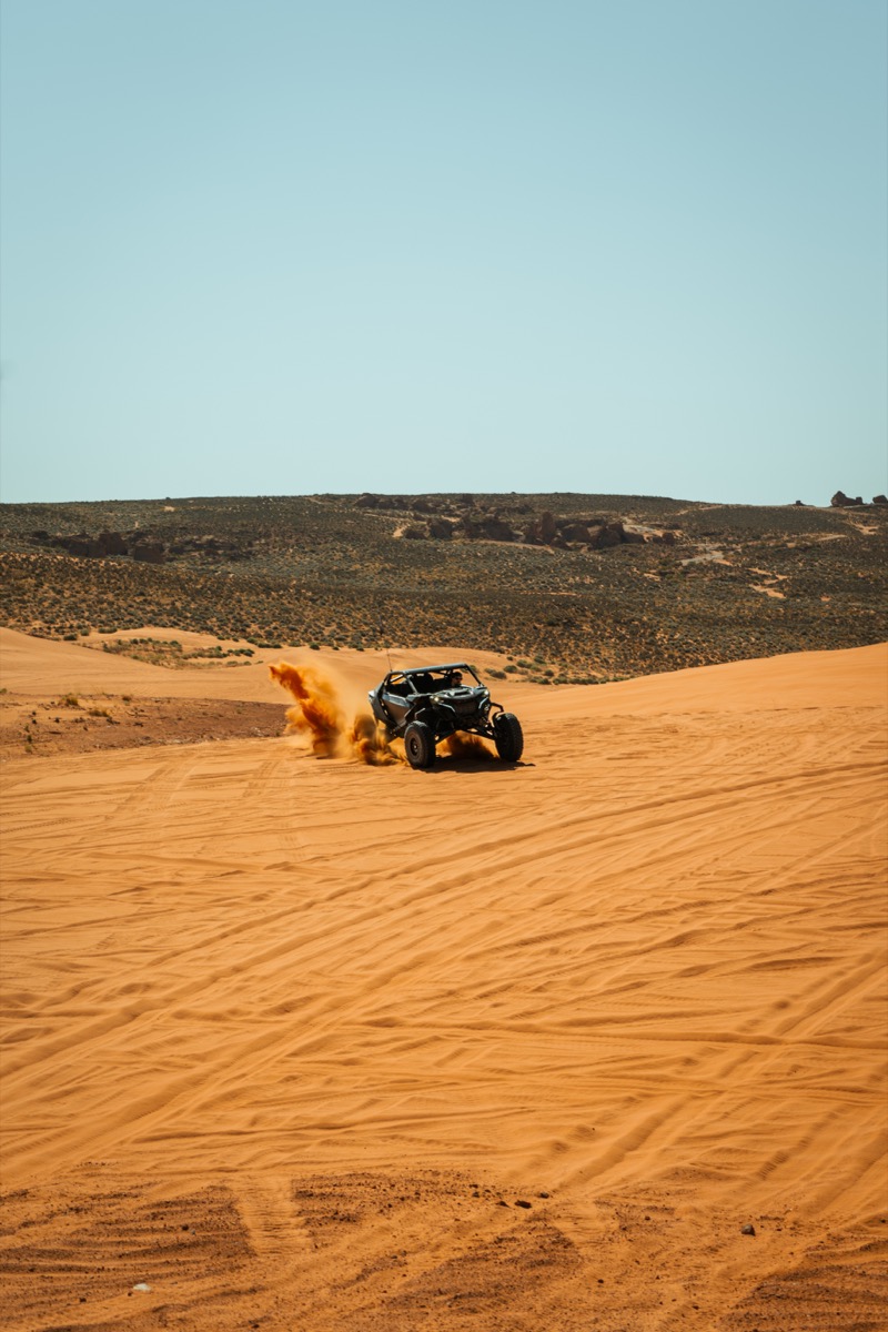 Can-Am Maverick throwing a roost of sand on Southern Utah dunes near Sand Hollow
