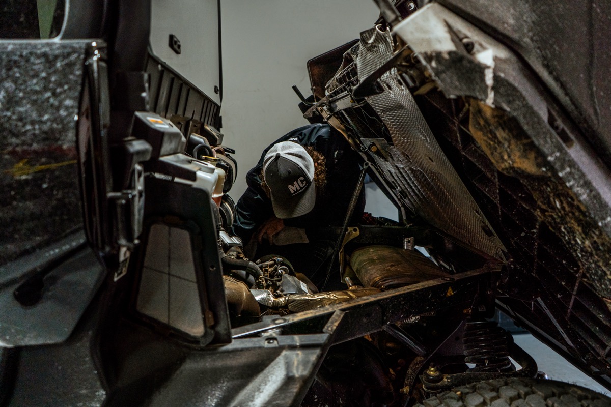 D&P Performance factory-trained technician working on a powersports vehicle in the Cedar City service bay with professional tools and equipment
