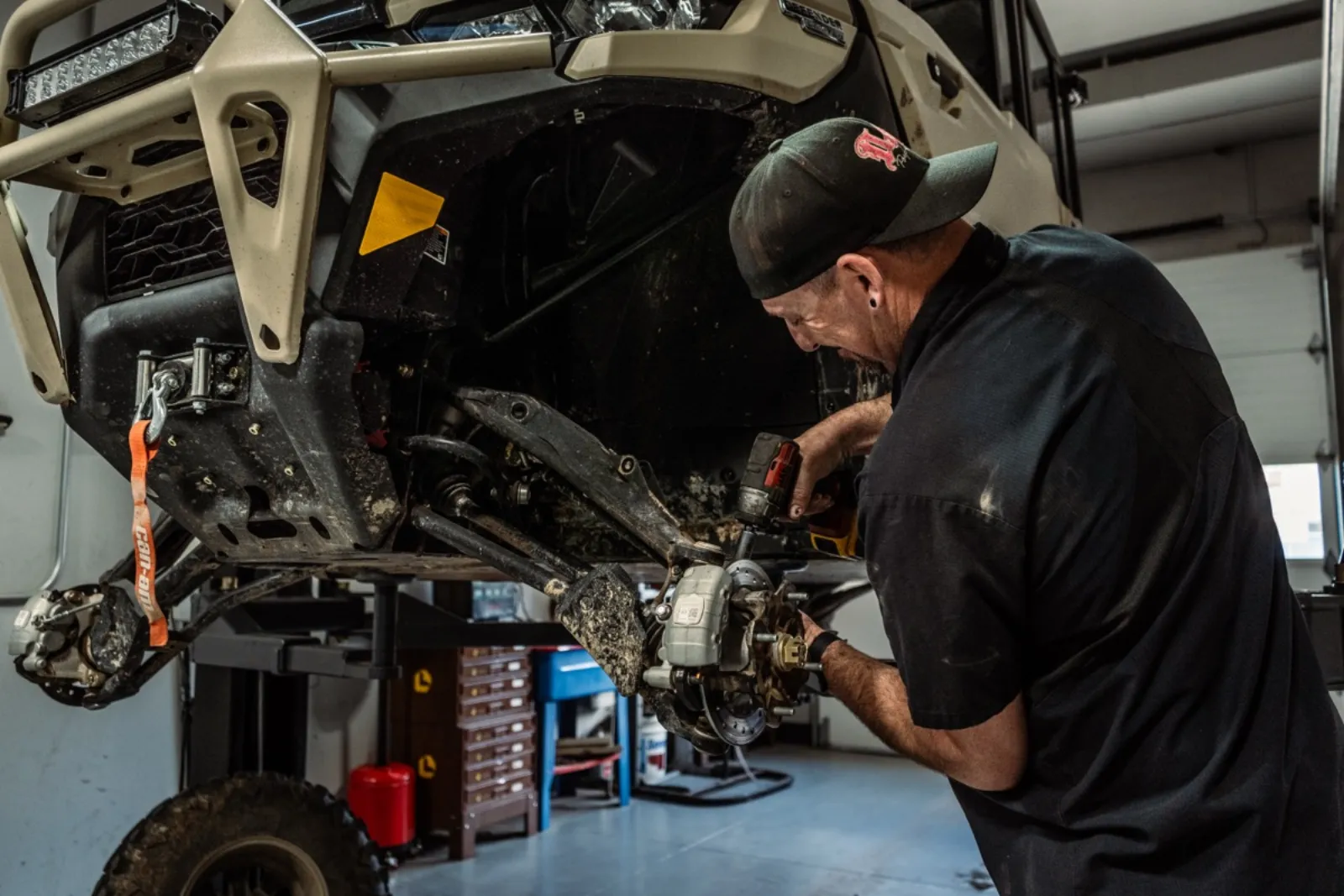 Technician servicing Polaris UTV drivetrain and suspension at D&P Performance Cedar City