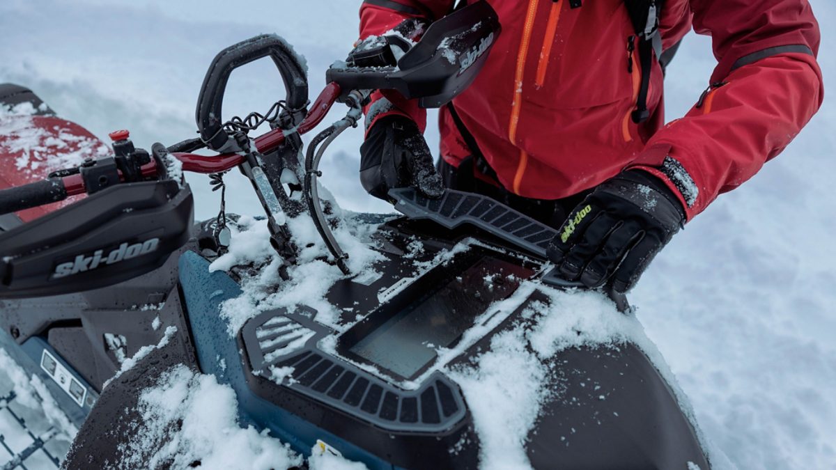 Ski-Doo Summit rider in deep powder with snow-covered handlebars showing the kind of riding conditions Utah backcountry demands