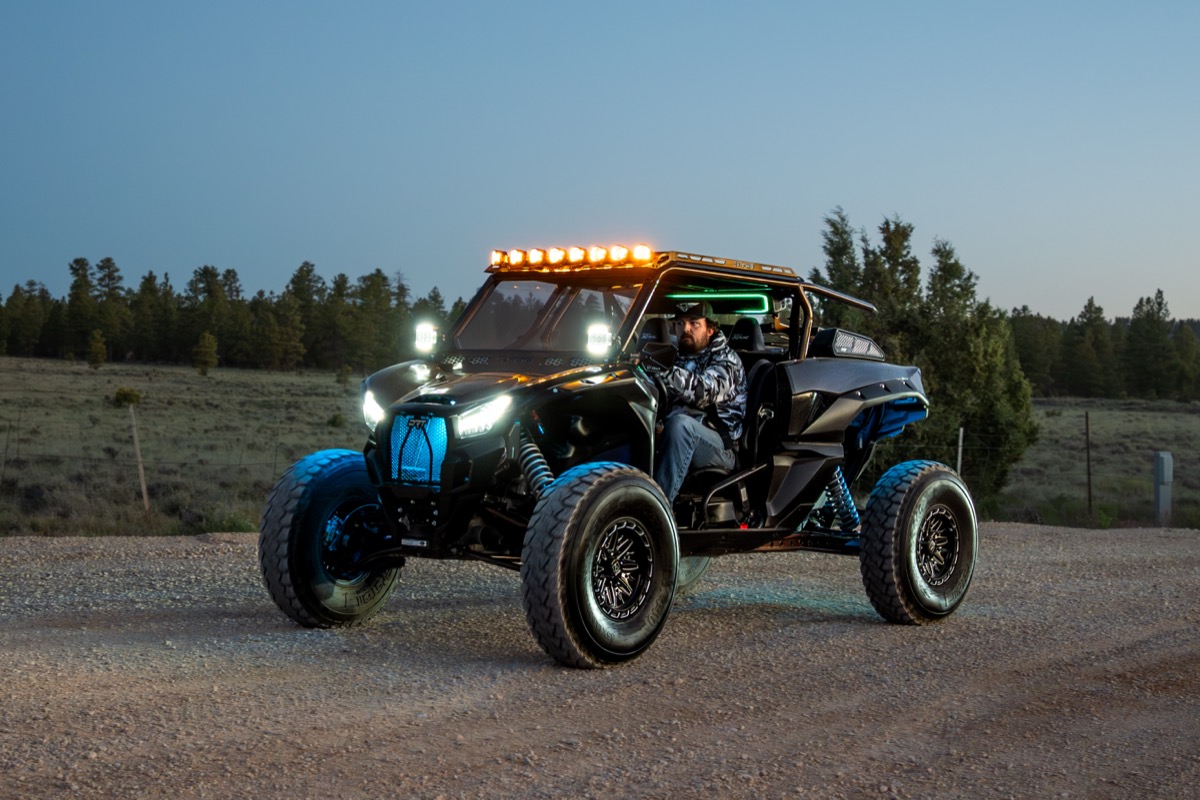 Can-Am UTV with aftermarket light bar and LED accessories on Southern Utah trail at dusk