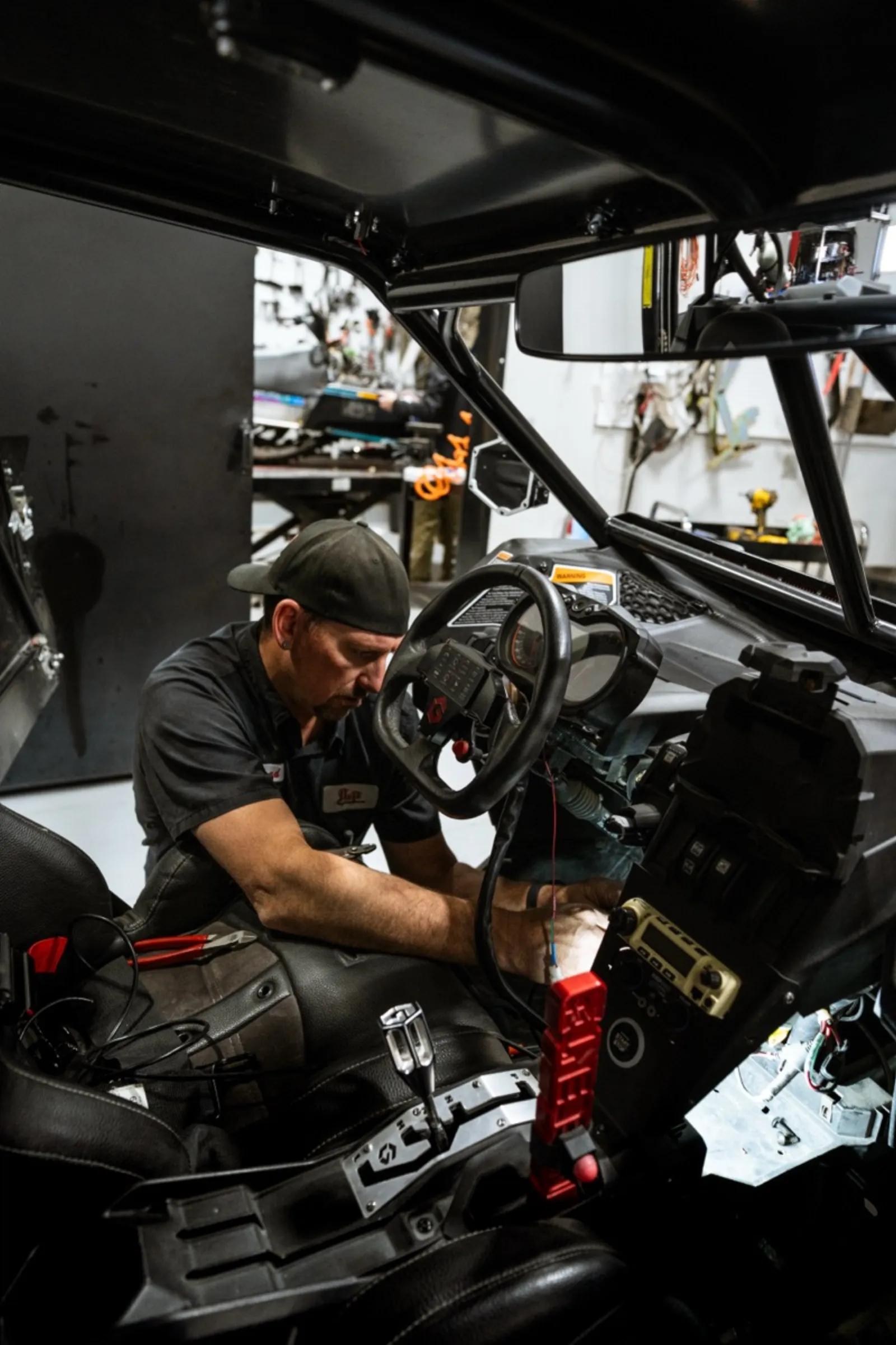 Technician running electrical diagnostics on UTV cockpit at D&P Performance service department