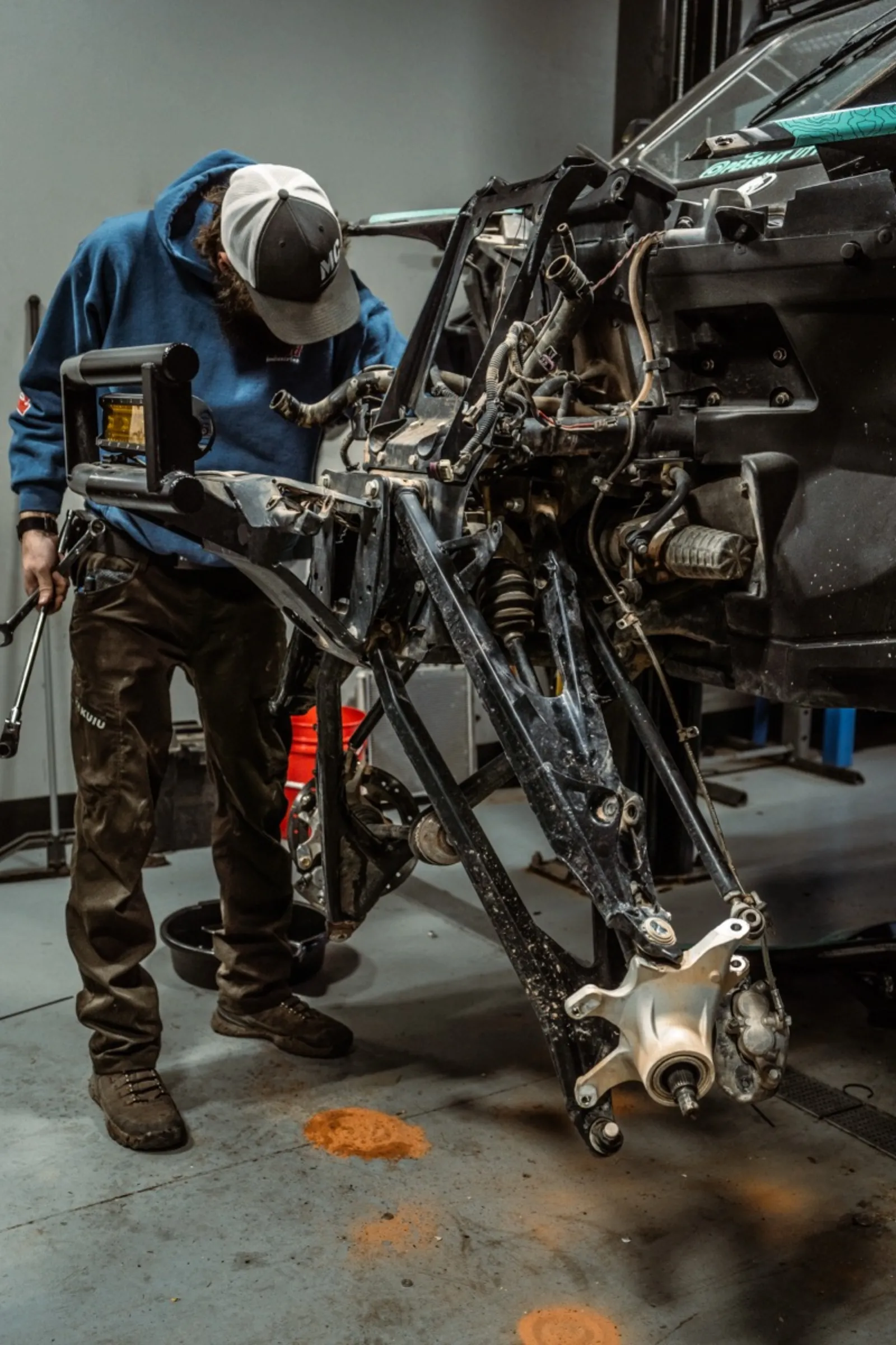 Technician performing detailed UTV frame and suspension repair at D&P Performance