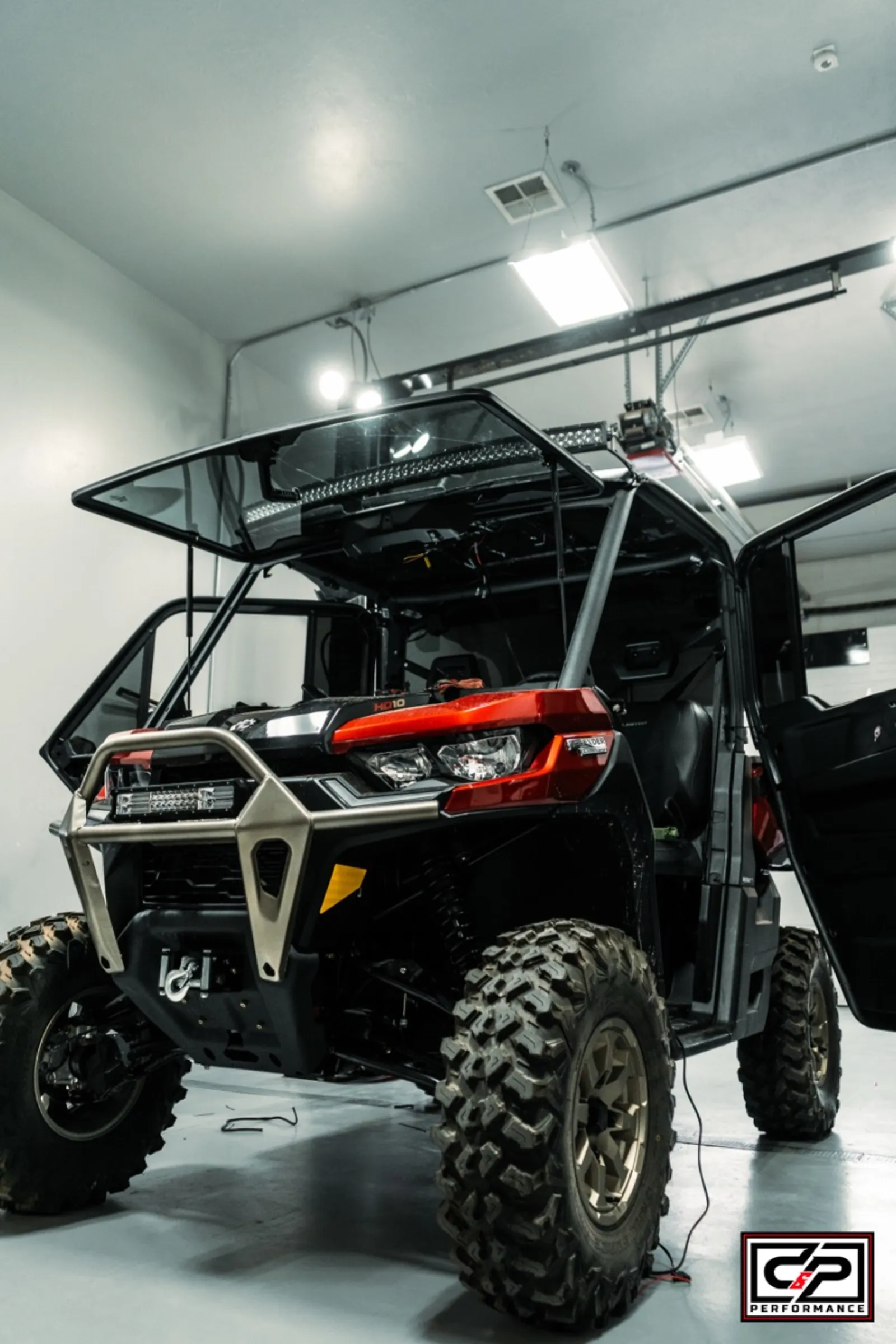 UTV with hood open in D&P Performance service bay ready for full inspection in Cedar City