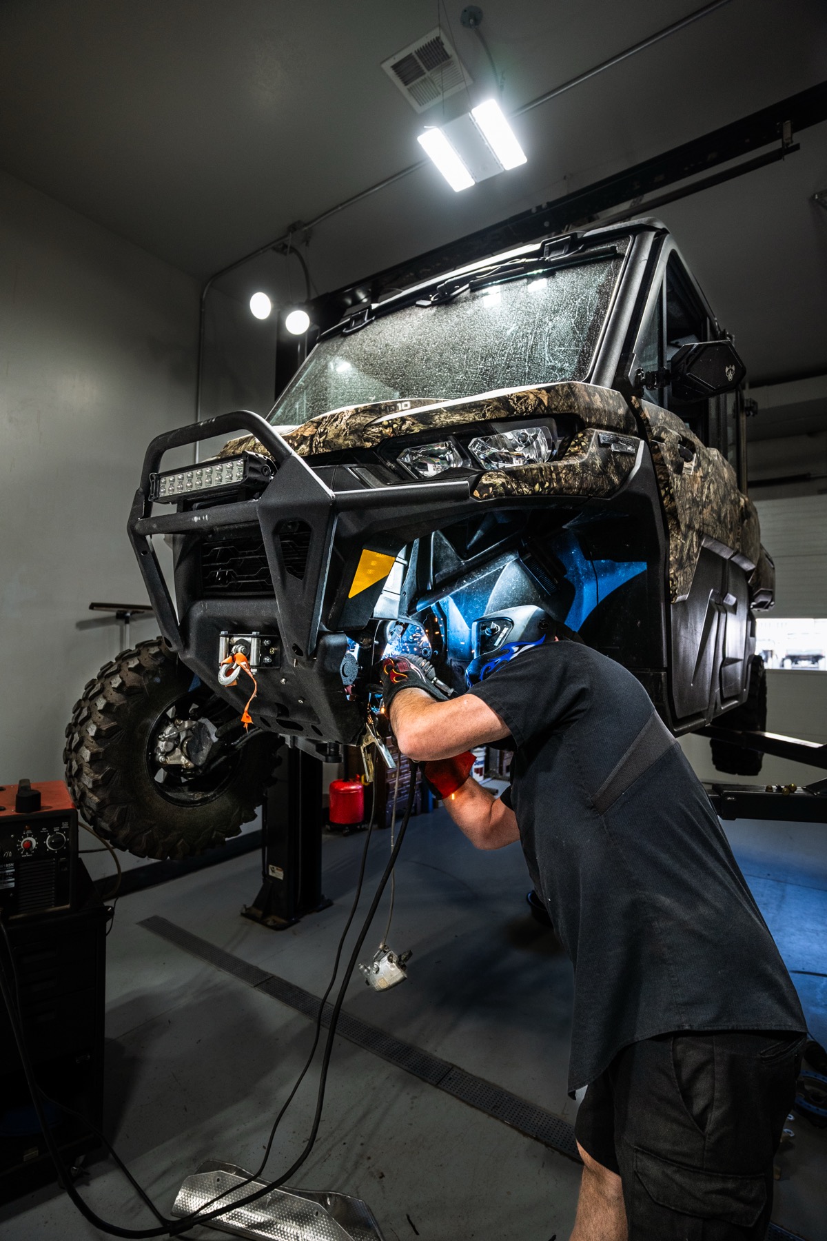 Factory-trained technician performing service on a UTV at D&P Performance shop in Cedar City Utah