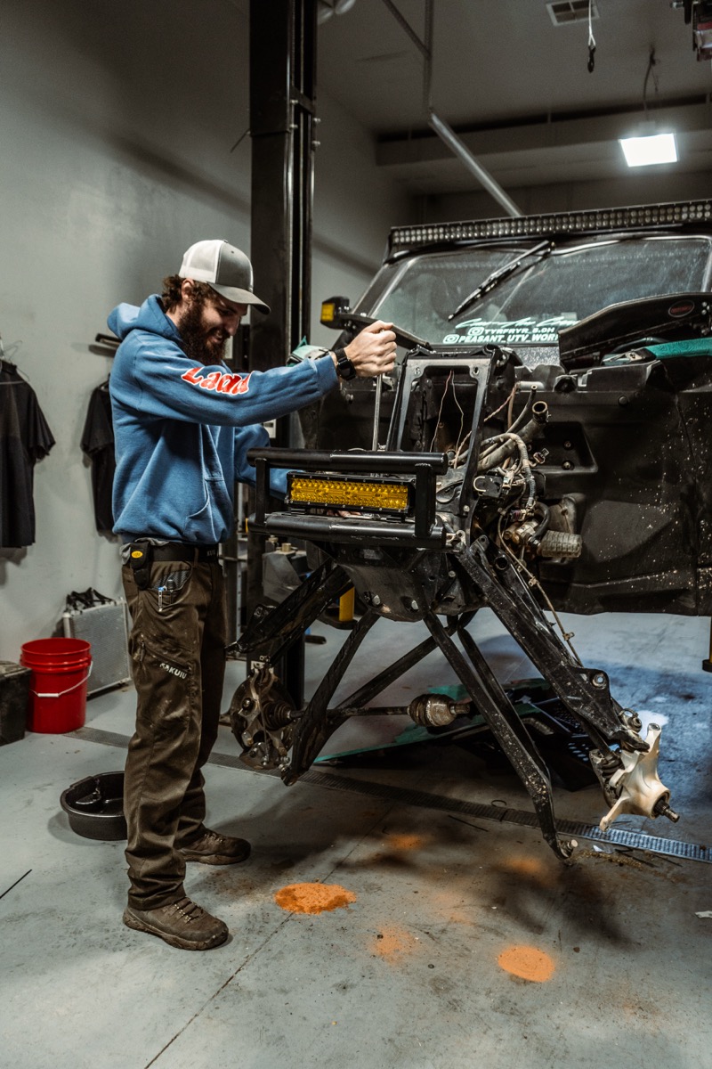 D&P Performance technician performing UTV service work in Cedar City Utah shop